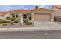 Charming single-story home with a tile roof, desert landscaping, and a two-car garage at 10801 Clarion Ln, Las Vegas, NV 89134