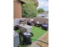 Cozy backyard with artificial turf, patio area, desert landscaping, and comfortable seating at 111 E Van Wagenen St, Henderson, NV 89015