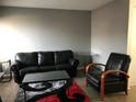 Comfortable living room with sleek black leather furniture and stylish décor at 111 E Van Wagenen St, Henderson, NV 89015