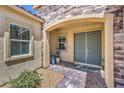 A charming front entrance features a double door, brick accents, and lush landscaping at 11238 Rebel Dome Ct, Las Vegas, NV 89141
