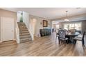Inviting living room featuring hardwood floors and an open floor plan leading to the dining area at 1610 Dire Wolf Avenue, North Las Vegas, NV 89084