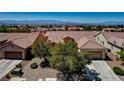High-angle view of a single-Gathering home with tile roof, front yard landscaping, and community neighborhood at 2183 Waterton Rivers Dr, Henderson, NV 89044