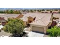 Beautiful aerial view of the single-Gathering home, showcasing the tile roof, desert landscaping, and attached garage at 2183 Waterton Rivers Dr, Henderson, NV 89044