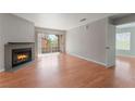 Open living room with a fireplace and sliding glass doors to balcony providing lots of light at 2200 S Fort Apache Rd # 2015, Las Vegas, NV 89117