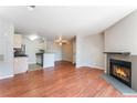Open concept: Living room with fireplace adjacent to kitchen, perfect for entertaining at 2200 S Fort Apache Rd # 2015, Las Vegas, NV 89117