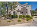 Beautiful condo exterior with rock landscaping, shrubs, and yellow flowers at 2325 Windmill Pkwy # 321, Henderson, NV 89074