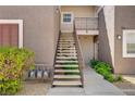 Exterior stairwell leading up to a condo building with metal railing and landscaped shrubbery on the sides at 2325 Windmill Pkwy # 321, Henderson, NV 89074