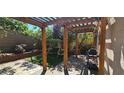 Backyard featuring a pergola, artificial turf, patio, swing, grill, and lush plants at 3131 Binaggio Ct, Las Vegas, NV 89141