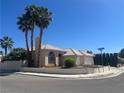 Lovely corner lot home boasts a tile roof, lush landscaping, and a spacious two-car garage at 3136 Jane Austin Ave, North Las Vegas, NV 89031