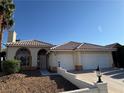 Inviting home featuring desert landscaping, palm trees, and a two-car garage at 3136 Jane Austin Ave, North Las Vegas, NV 89031