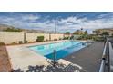 Community pool with clear blue water and mountain views, surrounded by a concrete deck at 3253 Mystic Ridge Ct, Las Vegas, NV 89129