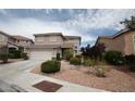 Two-story home featuring desert landscaping, a two-car garage, and a tile roof on a sunny day at 3440 Crystal Tower St, Las Vegas, NV 89129