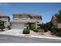 Two-story home featuring desert landscaping, a two-car garage, and a tile roof on a sunny day at 3440 Crystal Tower St, Las Vegas, NV 89129