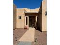 Covered front entrance with red rock landscaping and a slate tile path leading to the front door at 3551 Sagebrush Ave, Pahrump, NV 89048