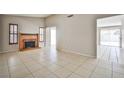 Living area featuring a brick fireplace, tile floors, and natural light streaming through the windows at 3596 Bronco Rd, Las Vegas, NV 89103