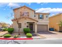 Inviting two-story home featuring desert landscaping and a brick paved driveway to a two car garage at 3855 Park Field Dr, Las Vegas, NV 89120