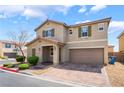 Inviting two-story home featuring desert landscaping and a brick paved driveway to a two car garage at 3855 Park Field Dr, Las Vegas, NV 89120
