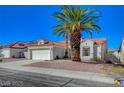 Inviting single-story home featuring mature palm trees, low maintenance landscaping, and a two car garage at 4010 Herblinda Ln, North Las Vegas, NV 89032