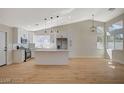 Bright kitchen boasts stainless appliances, a large island with white cabinets, recessed lights, and an open layout at 4010 Herblinda Ln, North Las Vegas, NV 89032