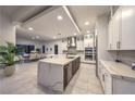 Bright modern kitchen with white cabinetry, stainless appliances, and a marble island at 461 Highview Ridge Ave, Las Vegas, NV 89138