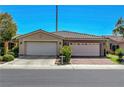 Close up of a home with a two-car garage, a neutral color scheme, and a tile roof at 4802 Regalo Bello St, Las Vegas, NV 89135
