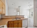 Kitchen with wood cabinets and a view of the living room at 4830 Double Down Dr # 102, Las Vegas, NV 89122