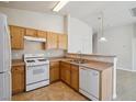 Bright kitchen with wood cabinets, stainless steel sink, and tile flooring at 4830 Double Down Dr # 102, Las Vegas, NV 89122