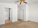 Spacious bedroom with a ceiling fan, carpet, and an en suite bathroom at 5373 Blue Oat Ave, Las Vegas, NV 89141