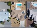 An aerial shot reveals a desert property with a pool, solar panels, and low-maintenance landscaping at 5450 Grain Mill Rd, Pahrump, NV 89061