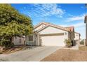 Charming single-story home featuring an attached two-car garage and nice landscaping at 5544 Cloudy Glen St, North Las Vegas, NV 89031