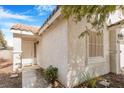 Close up of the front entrance showcasing a light-colored door, pillars and a window at 5544 Cloudy Glen St, North Las Vegas, NV 89031