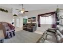 Inviting living room with tile flooring, ceiling fan, and comfortable seating, creating a relaxing atmosphere at 5884 Deer Valley Dr, Las Vegas, NV 89156