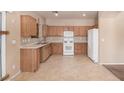 Spacious kitchen with ample cabinet space and white appliances at 6620 Tulip Falls Dr, Henderson, NV 89011