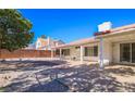 Spacious backyard with covered patio and desert landscaping, perfect for outdoor entertaining at 708 Canyon Country Cir, Henderson, NV 89002