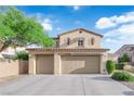 Two story home featuring a three car garage, desert landscaping, and a blue sky background at 7183 Majestic Bluff Pl, Las Vegas, NV 89113