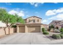 Charming two-story home featuring a three-car garage and lush landscaping, situated under a blue sky at 7183 Majestic Bluff Pl, Las Vegas, NV 89113