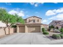 Two story home featuring a three car garage, desert landscaping, and a blue sky background at 7183 Majestic Bluff Pl, Las Vegas, NV 89113