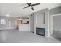 Bright living room featuring a fireplace, tile floors, view to kitchen, and updated lighting at 7189 S Durango Dr # 208, Las Vegas, NV 89113
