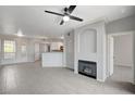 Open-concept living room showcasing tile floors, a cozy fireplace, and neutral paint, creating a welcoming space at 7189 S Durango Dr # 208, Las Vegas, NV 89113