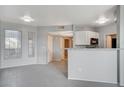 Bright living room featuring modern lighting, view to kitchen, and white trim at 7189 S Durango Dr # 208, Las Vegas, NV 89113