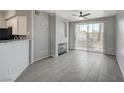 Bright living room featuring modern tile floors, fireplace, and sliding glass doors to the outdoor patio at 7189 S Durango Dr # 208, Las Vegas, NV 89113