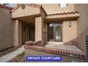 Cozy front courtyard providing a private entrance, with brick accents, perfect for relaxing and entertaining at 7365 Mission Hills Dr, Las Vegas, NV 89113