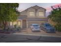 Two-story home features a well-kept front yard and an attached two-car garage, with a sunset background at 7856 Tolberts Mill Dr, Las Vegas, NV 89131
