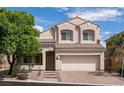 Charming two-story home showcasing a tile roof, attached garage, and low-maintenance front yard landscaping at 7856 Tolberts Mill Dr, Las Vegas, NV 89131