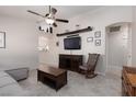 Comfortable living room with neutral tones, ceiling fan, and tile flooring provides an inviting space at 7904 Seabourn Ct, Las Vegas, NV 89129