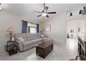 Comfortable living room with neutral tones, ceiling fan, and tile flooring provides an inviting space at 7904 Seabourn Ct, Las Vegas, NV 89129