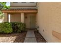 Inviting front porch with a security door, desert landscaping and a neutral color scheme at 7912 Horn Beam Ct, Las Vegas, NV 89131