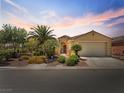 Single-story home with desert landscaping, a gated courtyard and two-car garage at 8409 Sherwood Park Dr, Las Vegas, NV 89131