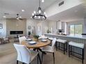 Open-concept dining area with modern lighting and a seamless connection to the stylish kitchen at 9369 Villa Ridge Dr, Las Vegas, NV 89134