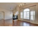 Spacious living room showcasing a fireplace, large window, and wood floors at 9994 Government Point Way # 101, Las Vegas, NV 89183